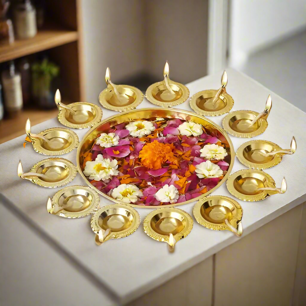 Decorative gold diya with flowers on a neutral background