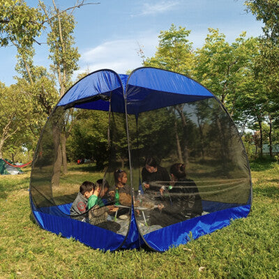 Outdoor canopy tent with people sitting inside in a park setting