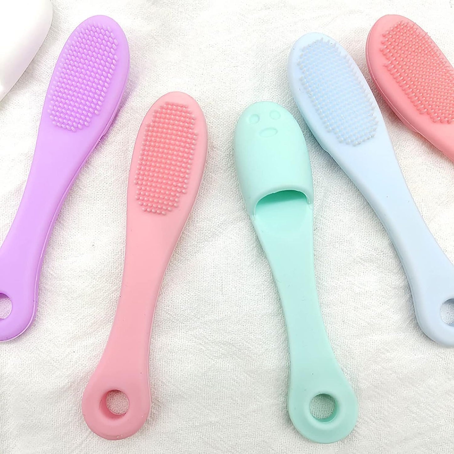 Set of five colorful baby brushes on a white background