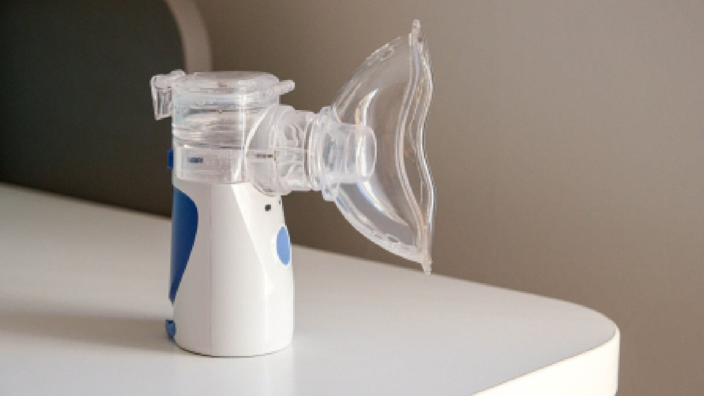 Nebulizer device on a white surface with a neutral background