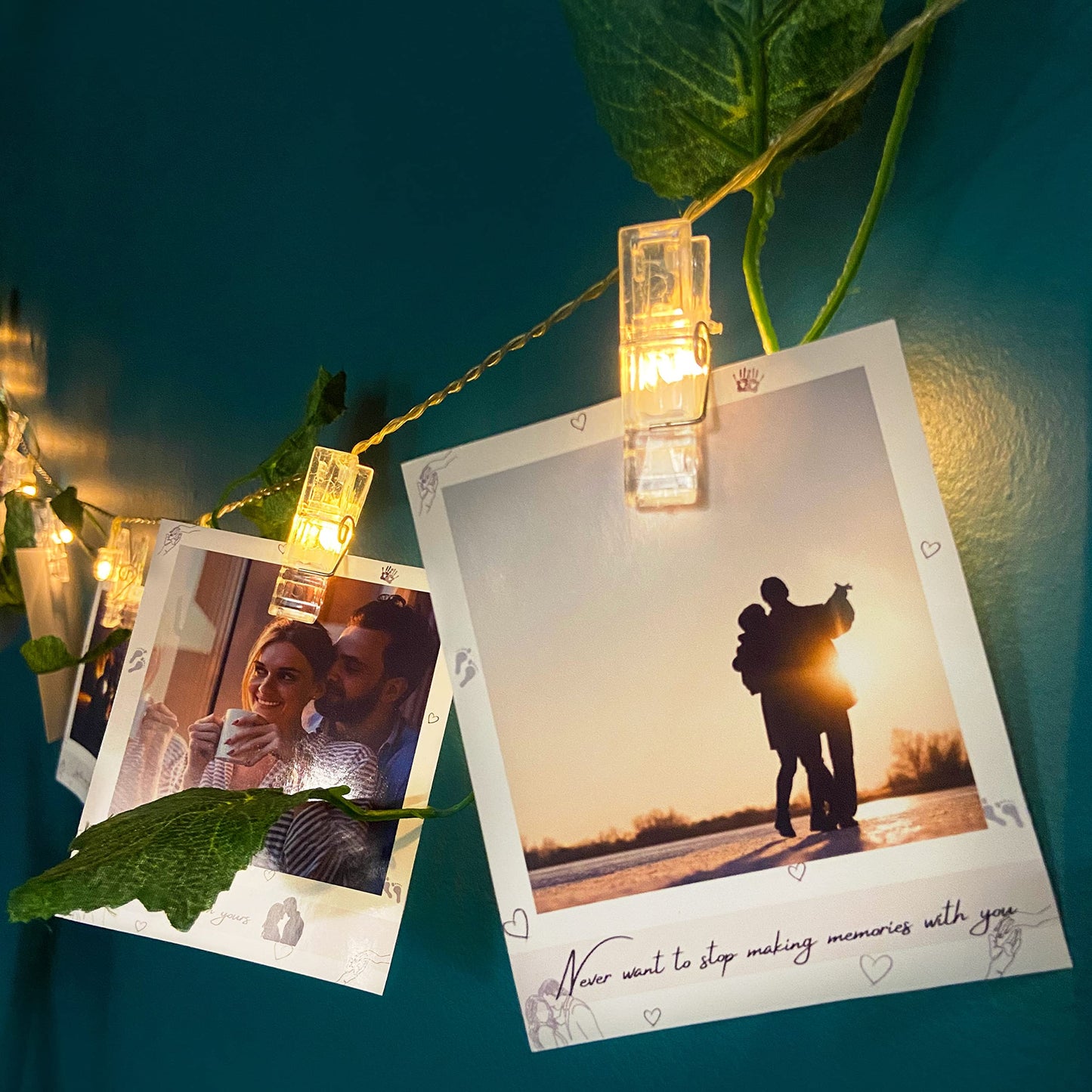 Two photos of a couple clipped to a string with lights on a blue background