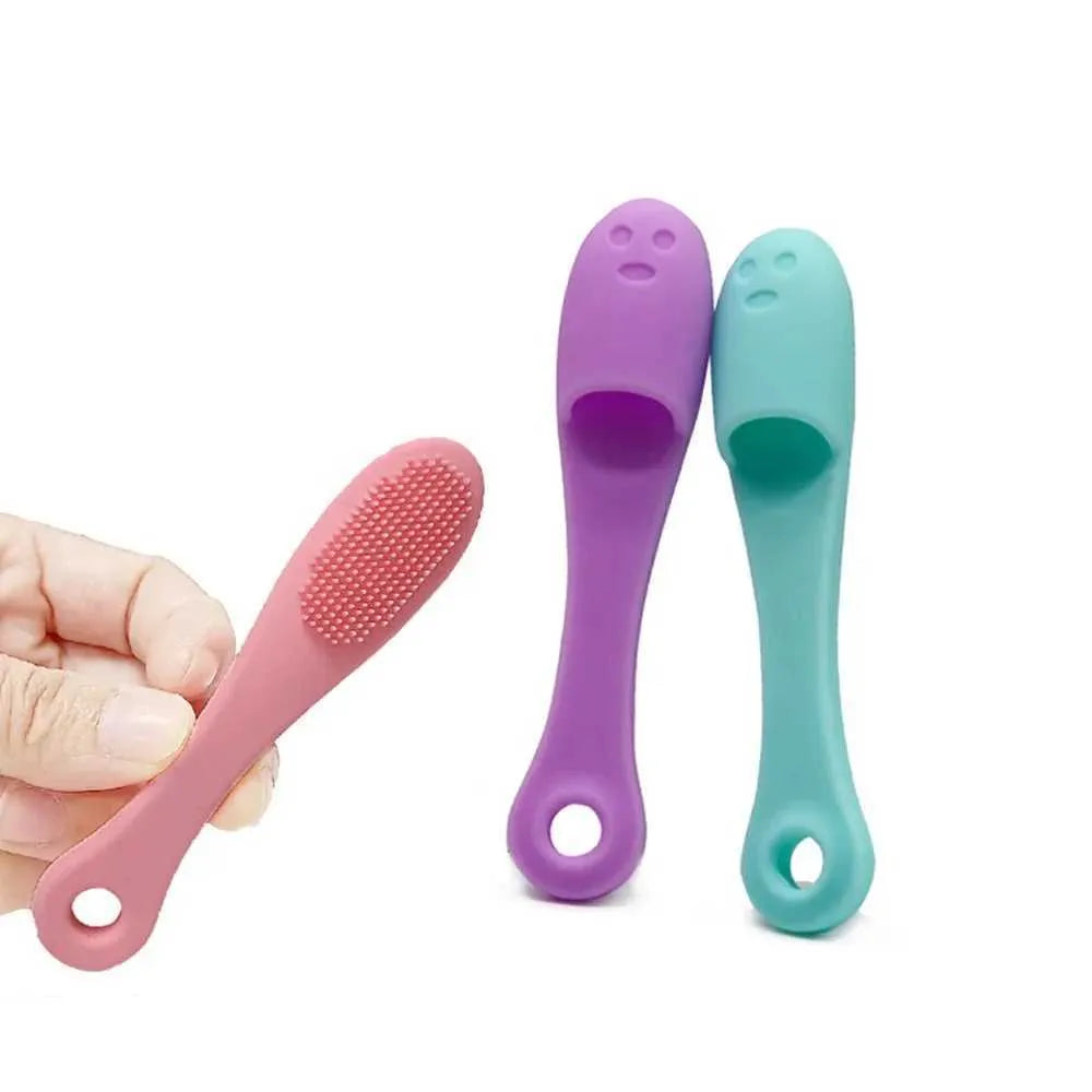 Pink, purple, and teal baby brushes held by a hand on a white background